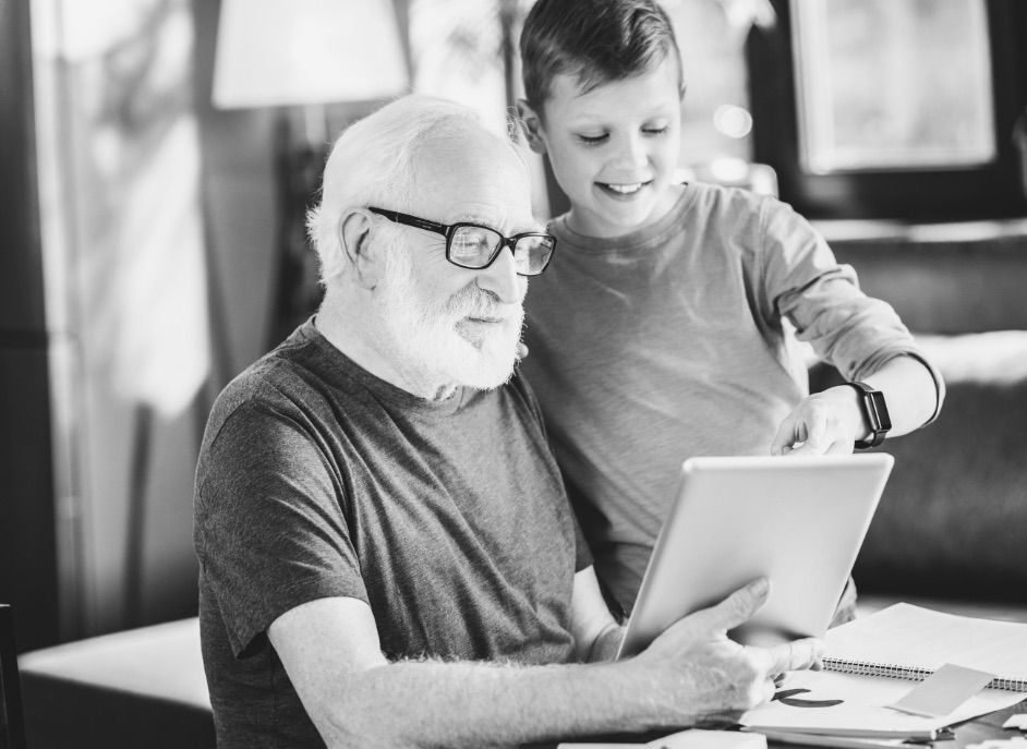 Mature man and boy looking at tablet